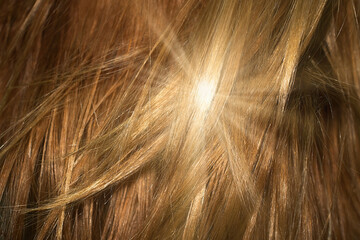 Naklejka premium Brown shiny hair as background. Sun flare
