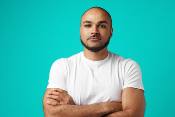Young black man standing with crossed arms