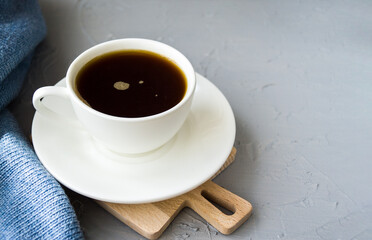 Still life with a Cup of coffee and a knitted scarf. Winter and autumn mood.