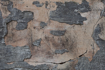 Stripped concrete wall texture with cracks and scratches. Fragment of old castle wall, for background or texture.