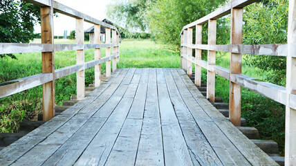 Fototapeta na wymiar Old vintage wooden footbridge. The architecture is an old wooden bridge.