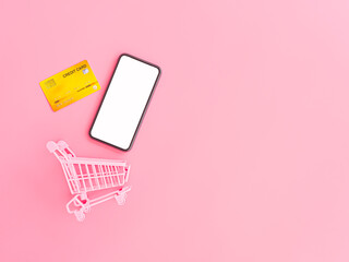 shopping and payment online concept from pink purse, credit cards, shopping cart and blank...