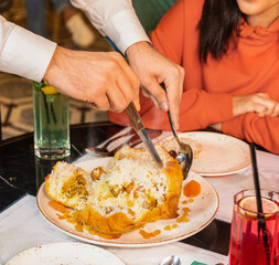 Waiter cutting a Shah Pilaf at restaurant