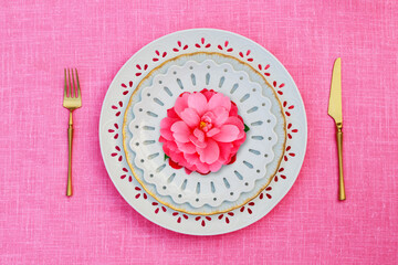 Porcelain heart openwork lace plates  and Table place setting with gold set of cutlery  knifes, forks, on pink  linen tablecloth. Valentine Day or Mother Day, Wedding floral background, close up