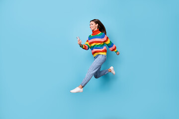 Fototapeta na wymiar Full length body size profile side view of her she nice attractive pretty cheerful cheery girl jumping running using 5g app fast speed wi-fi roaming isolated blue pastel color background