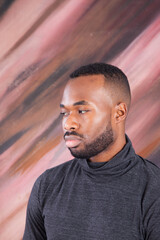 Fototapeta premium Handsome Black man looking Pensive in a grey shirt