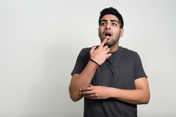 Portrait of young handsome bearded Indian man