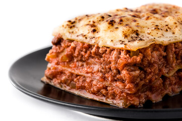 Piece of meat lasagna on black plate isolated on white background
