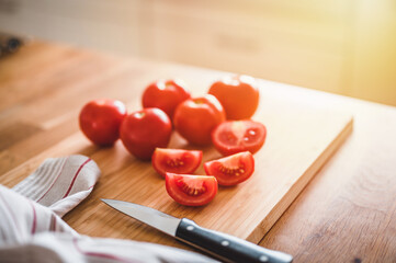 Fresh ripe garden tomatoes and knife on wooden table. 