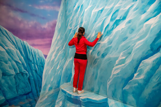 Back View Of A Woman Climbing Ice Wall