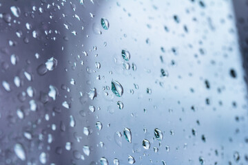 A small raindrop rests on the glass after rain.
