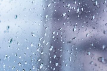 A small raindrop rests on the glass after rain.