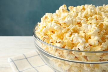 Bowl with popcorn on white wooden background. Food for watching cinema