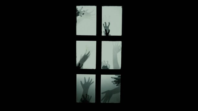 Scary hands scratching the glass door. Nightmare, spooky, ghost scene. Creepy halloween scene.