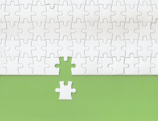 Green background made from white puzzle pieces and copy space for content