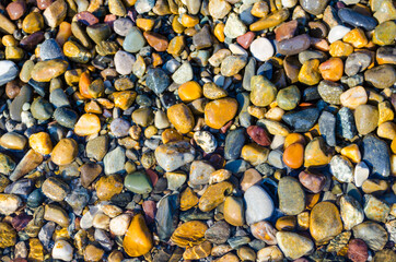 sea pebbles on the beach, background, vacation on the coast.Sea, sun and salt water on the beach.