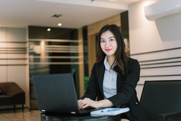 asian business woman using laptop computer in office