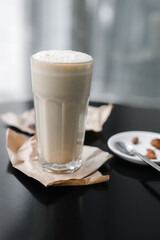 cold coffee frappuccino with foam on the black table