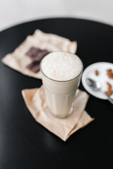 cold coffee frappuccino with foam on the black table