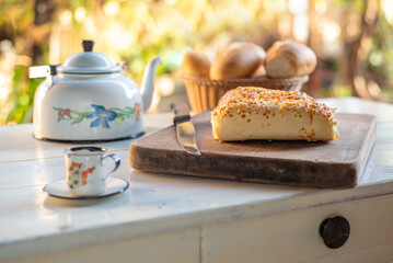 Cafe table with breads, crackers and accessories with blurred background, natural light on white table, selective focus