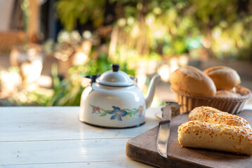 Cafe table with breads, crackers and accessories with blurred background, natural light on white table, selective focus