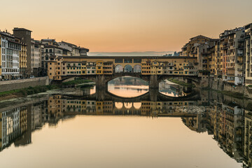 Sunrise at Ponte Vecchio bridge over Arno river in Florence, Italy.