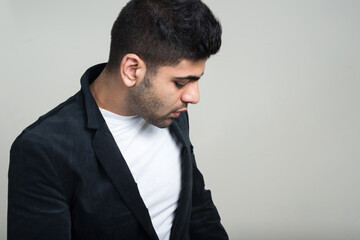 Portrait of young handsome bearded Indian businessman