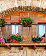 Fototapeta na wymiar Facade of ancient house decorated with flowers