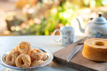 Cafe table with breads, crackers and accessories with blurred background, natural light on white table, selective focus