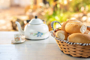 Cafe table with breads, crackers and accessories with blurred background, natural light on white table, selective focus