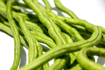 Bunch of green long bean on white background.