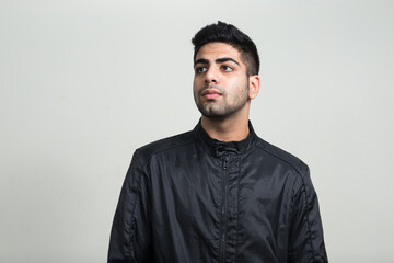 Fototapeta premium Portrait of young handsome bearded Indian man