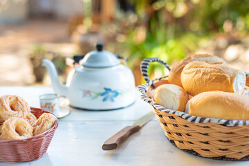 Cafe table with breads, crackers and accessories with blurred background, natural light on white table, selective focus