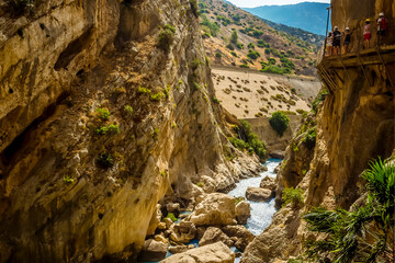 Obraz premium A view of the Caminito del Rey pathway suspended above the Gaitanejo river near Ardales, Spain in the summertime