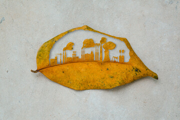 The city building cutting dry leaf. The city and industrial factory growth on the earth. Industrail...