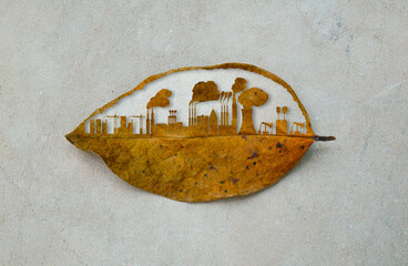 The city building cutting dry leaf. The city and industrial factory growth on the earth. Industrail...