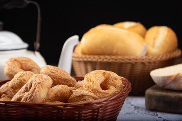 Breakfast table with cookies, breads and accessories on lace tablecloth and rustic wood, selective focus