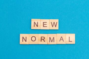 NEW NORMAL word from wooden blocks. New normal after covid-19 pandemic concenpt. Social distance