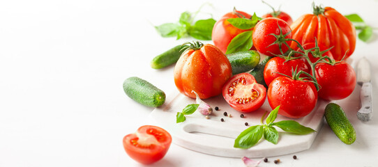 Fototapeta na wymiar Healthy food concept with fresh ripe tomatoes, cucumbers, radish, basil, garlic and spices. Clean eating