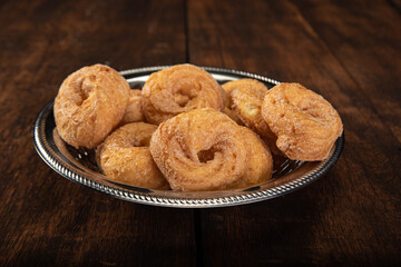 sweet cookies in a stainless steel container on rustic wood, selective focus
