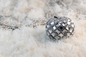 One silver christmas ball on white