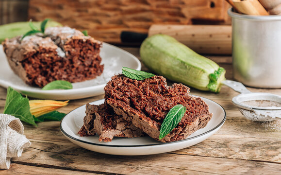 Vegan crunchy chocolate zucchini cake on rustic wooden. Healthy gluten free food. Selective focus