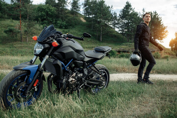 Fototapeta na wymiar Image of biker and motorcycle on the country road.