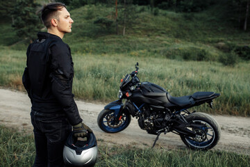 Obraz premium Image of biker and motorcycle on the country road.