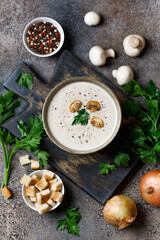 Mushroom cream soup on dark background. Champignon soup