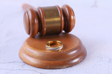 Close up of ring and gavel on wooden table 