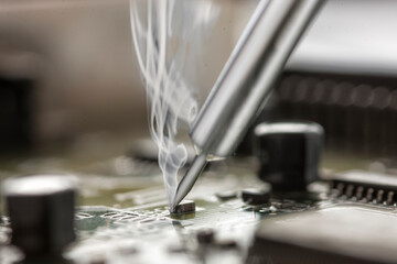 soldering iron on a motherboard