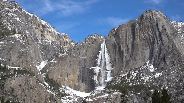 Medium shot of frozen Yosemite Falls in Winter at Yosemite National Park