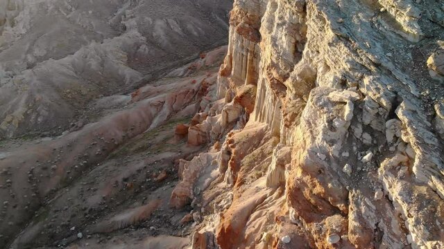 Cinematic aerial flyover of sandstone formations in canyon in Mojave Desert, California
