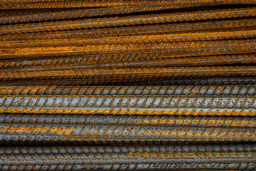 Rusty steel rods. Material for the construction of buildings and houses. Strong metallic material forming a repeating pattern
